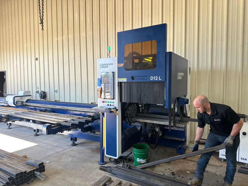 Tube laser cutting machine set up on a fabrication shop floor